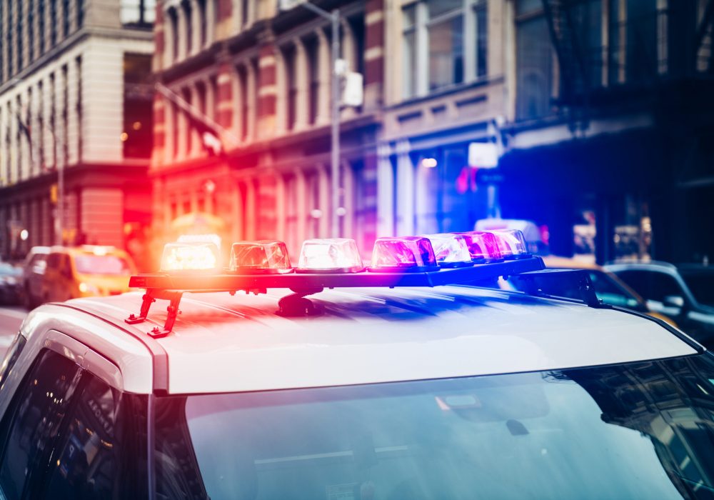 Police car with alarm and signal light flashes on the roof rush emergency call in New York City Police car with alarm and signal light flashes on the roof rush emergency call in New York City